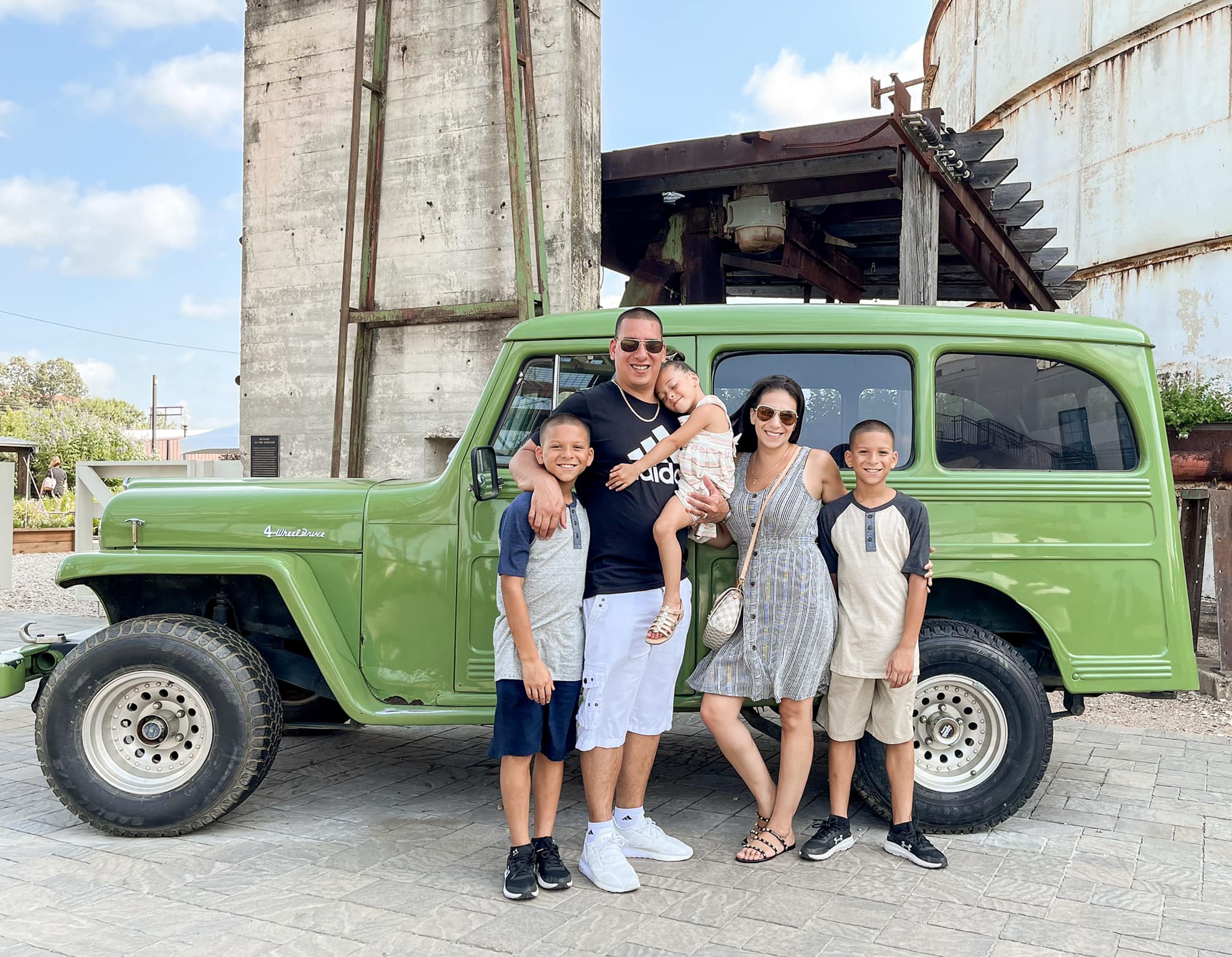 Family by a green Jeep
